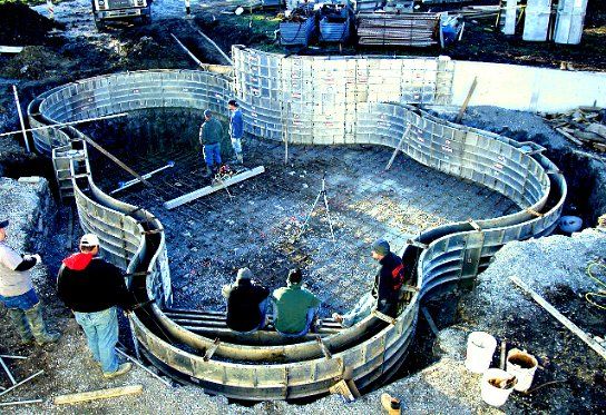 Freeform all-concrete pool fully formed, with the crew ready for concrete placement