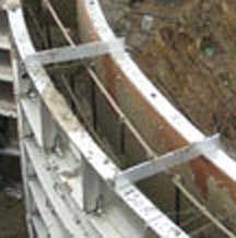 Parapet brackets spanning the top of radius forms on a jobsite