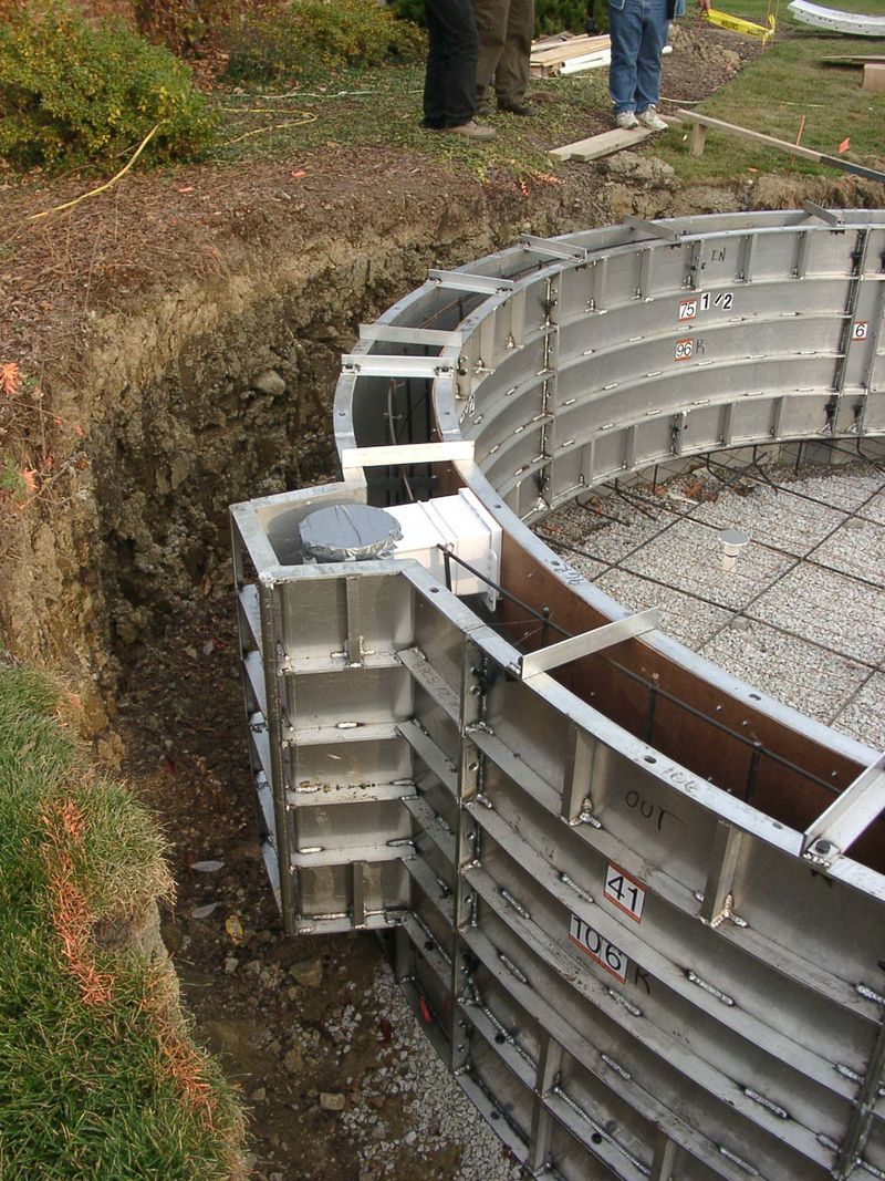 Pilaster form with a skimmer set into a radius pool wall