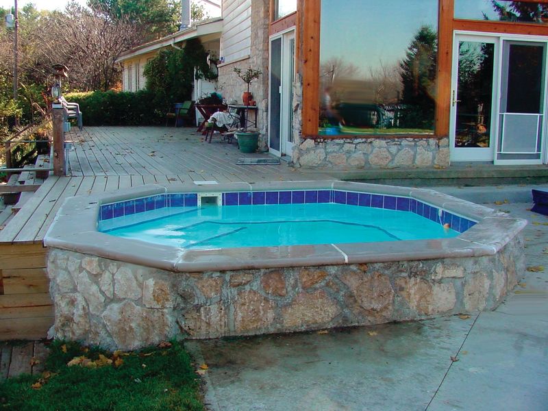 Raised concrete spa finished in stone