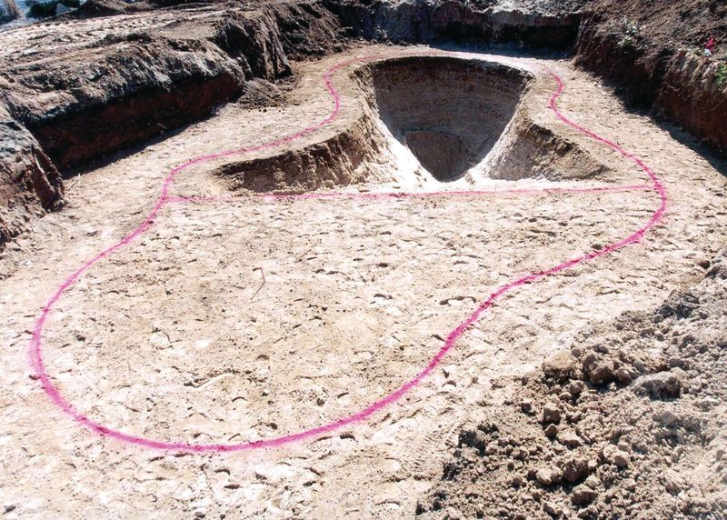 Pool shape marked out on the ground with the hopper excavated